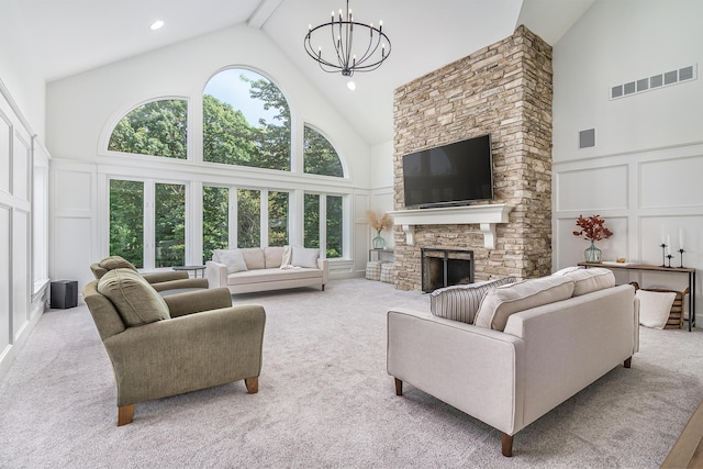 3603 Elk Ct, Zeeland, MI 49464 - carpeted living room with a decorative wall, high vaulted ceiling, a chandelier, and a stone fireplace