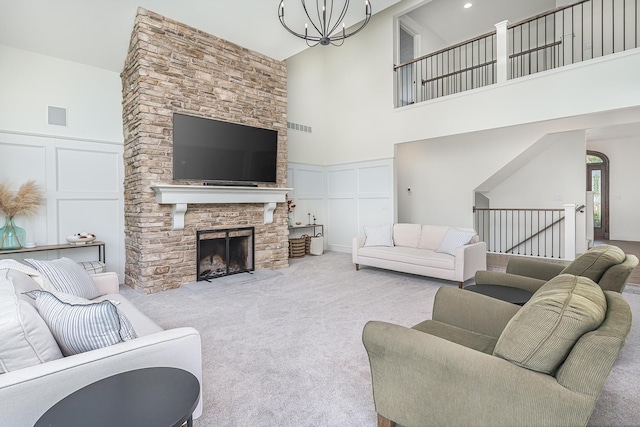 3603 Elk Ct, Zeeland, MI 49464 - living area featuring a decorative wall, a towering ceiling, carpet flooring, a fireplace, and a chandelier