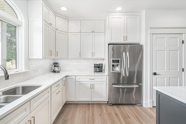 3603 Elk Ct, Zeeland, MI 49464 - kitchen featuring stainless steel refrigerator with ice dispenser, recessed lighting, tasteful backsplash, light countertops, and light wood-type flooring