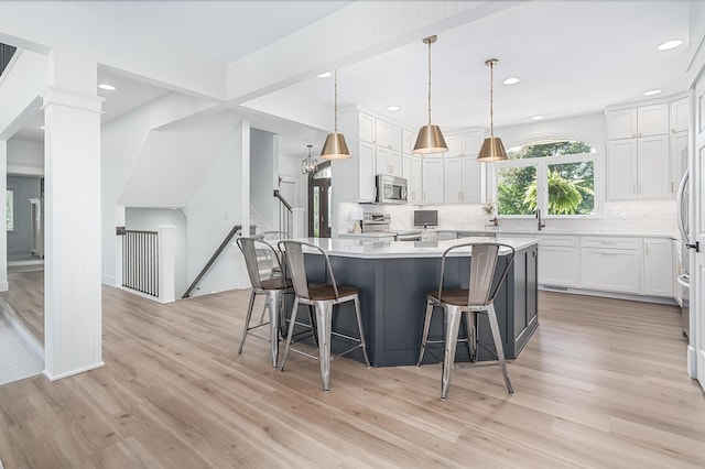 3603 Elk Ct, Zeeland, MI 49464 - kitchen with appliances with stainless steel finishes, backsplash, light countertops, light wood-style flooring, and recessed lighting