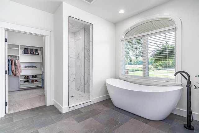 3603 Elk Ct, Zeeland, MI 49464 - full bathroom with a spacious closet, a marble finish shower, a soaking tub, and recessed lighting