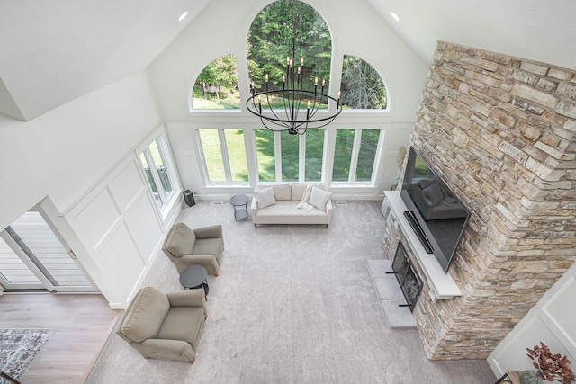 3603 Elk Ct, Zeeland, MI 49464 - living room featuring high vaulted ceiling, a chandelier, and wood finished floors