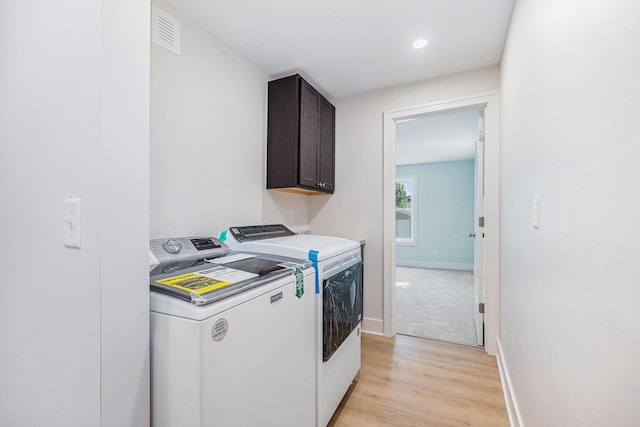 854 First St NW, Grand Rapids, MI 49504 - laundry area featuring washing machine and clothes dryer, cabinet space, light wood finished floors, and recessed lighting