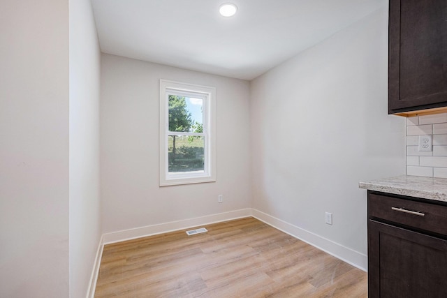 854 First St NW, Grand Rapids, MI 49504 - unfurnished dining area featuring light wood-style flooring and baseboards