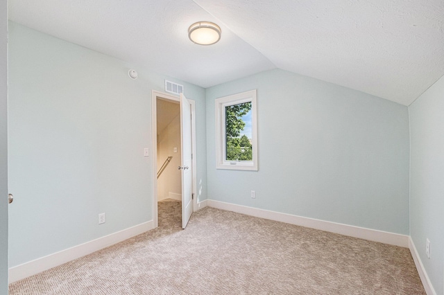 854 First St NW, Grand Rapids, MI 49504 - unfurnished bedroom with light carpet and vaulted ceiling
