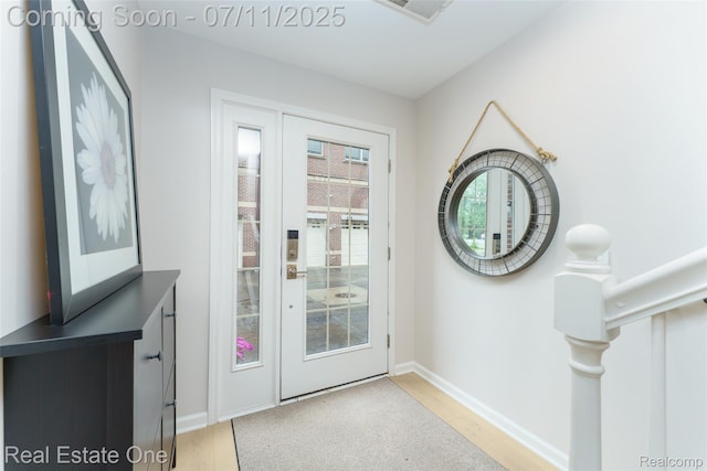 105 S 2nd St, Brighton, MI 48116 - doorway to outside featuring light wood finished floors and baseboards