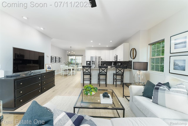 105 S 2nd St, Brighton, MI 48116 - living room featuring light wood finished floors, a chandelier, and recessed lighting