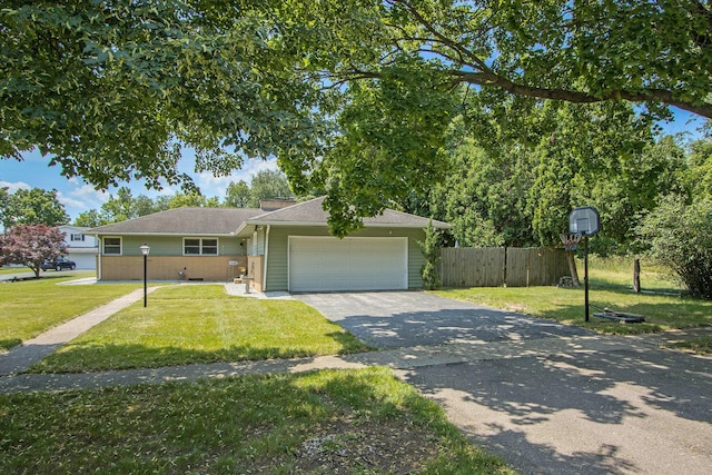 3715 Lancaster Dr, Kalamazoo, MI 49006 - ranch-style house featuring asphalt driveway and an attached garage