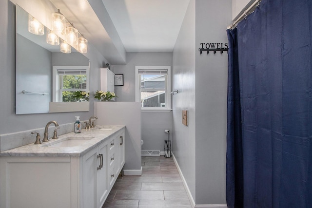 3715 Lancaster Dr, Kalamazoo, MI 49006 - bathroom featuring double vanity and a shower with curtain