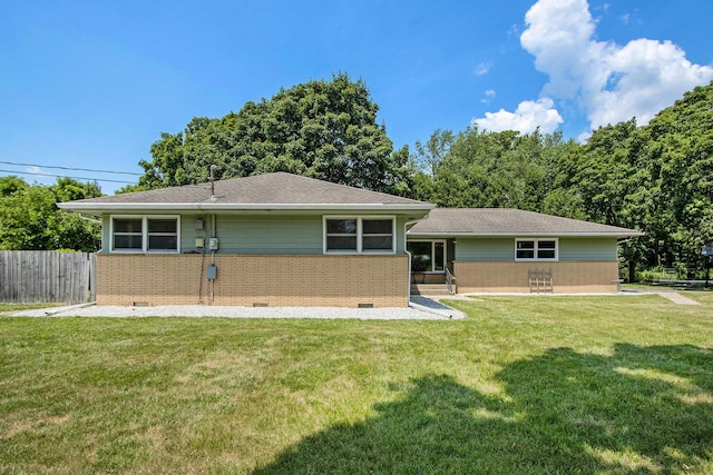 3715 Lancaster Dr, Kalamazoo, MI 49006 - back of property with crawl space, brick siding, and roof with shingles