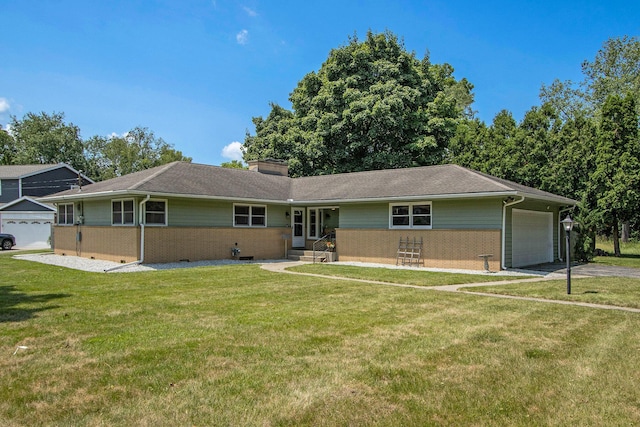 3715 Lancaster Dr, Kalamazoo, MI 49006 - ranch-style home featuring a garage, brick siding, a front yard, driveway, and a chimney