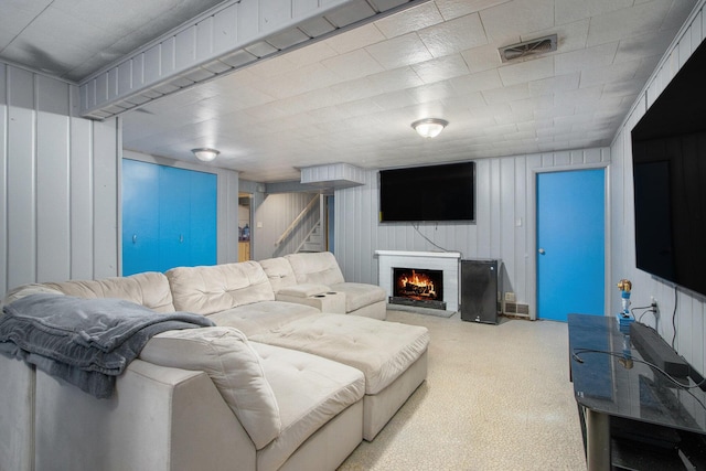 3715 Lancaster Dr, Kalamazoo, MI 49006 - living area featuring carpet flooring, a lit fireplace, and stairway