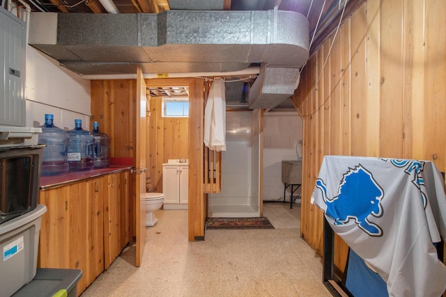 3715 Lancaster Dr, Kalamazoo, MI 49006 - basement featuring light flooring and wooden walls