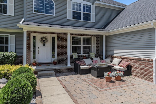 5775 Libby Ct, Dexter, MI 48130 - doorway to property with brick siding, an outdoor living space, and a shingled roof