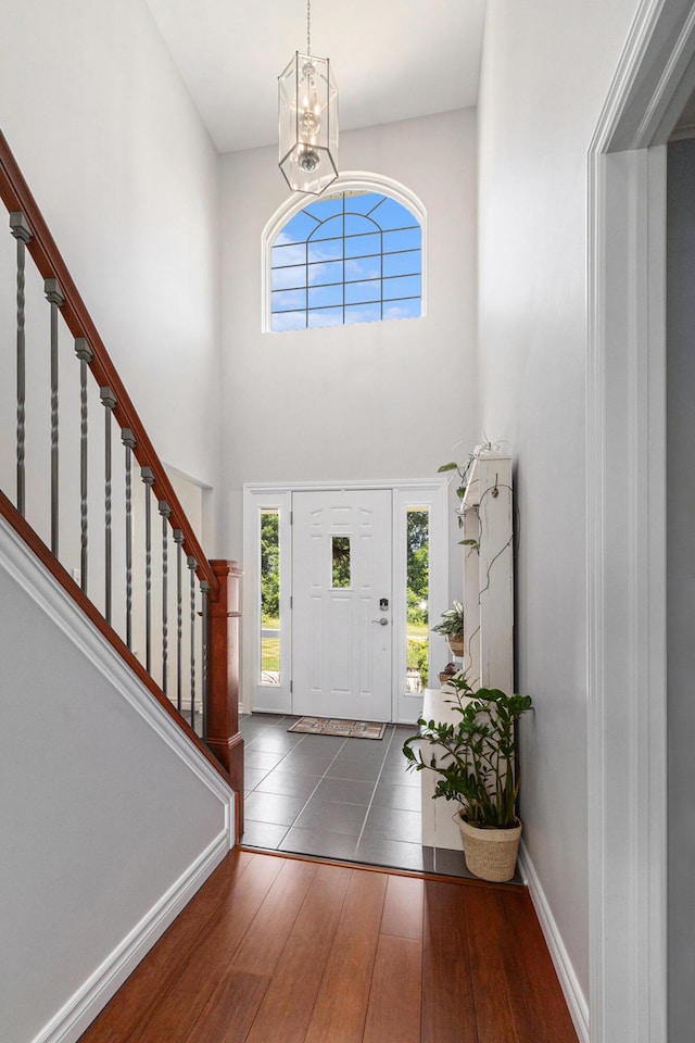 5775 Libby Ct, Dexter, MI 48130 - entrance foyer featuring a chandelier, hardwood / wood-style flooring, stairway, and a towering ceiling
