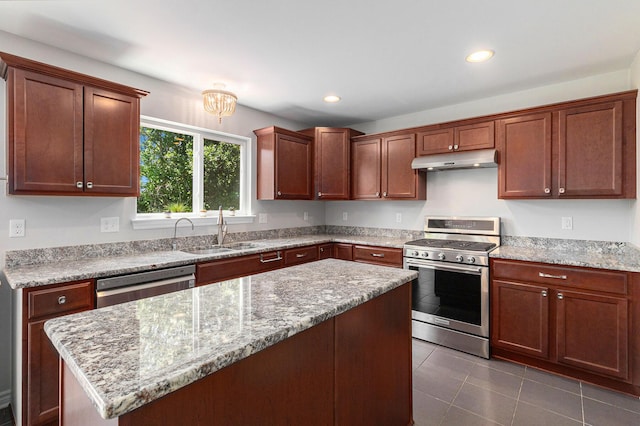 5775 Libby Ct, Dexter, MI 48130 - kitchen with appliances with stainless steel finishes, under cabinet range hood, recessed lighting, a center island, and dark tile patterned flooring