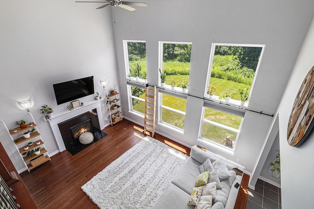 5775 Libby Ct, Dexter, MI 48130 - living room with a high ceiling, ceiling fan, a fireplace with flush hearth, and wood finished floors