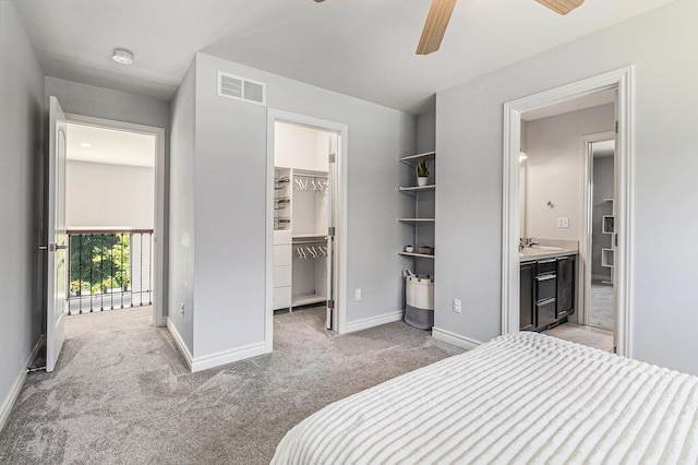 5775 Libby Ct, Dexter, MI 48130 - bedroom featuring light colored carpet, a walk in closet, a closet, and a ceiling fan