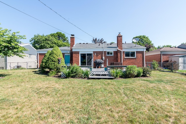 39079 Ross St, Livonia, MI 48154 - rear view of house featuring a chimney, brick siding, and a wooden deck