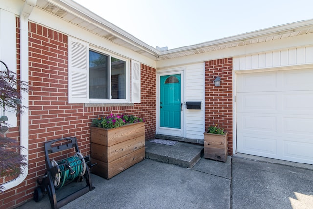 39079 Ross St, Livonia, MI 48154 - doorway to property featuring brick siding and a garage
