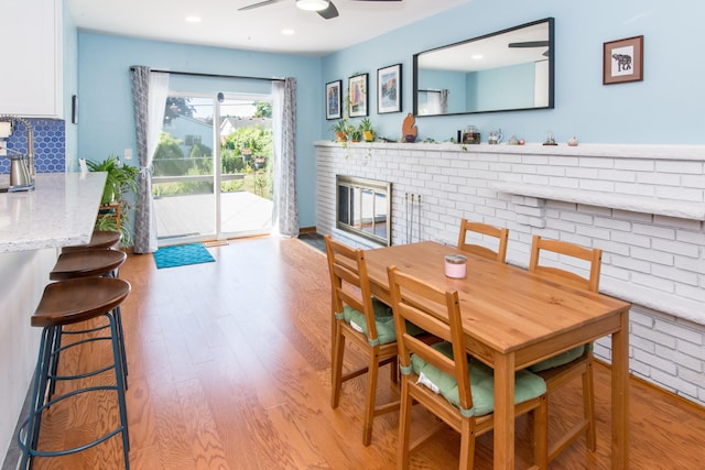 39079 Ross St, Livonia, MI 48154 - dining room with a ceiling fan, light wood-type flooring, a fireplace, and recessed lighting
