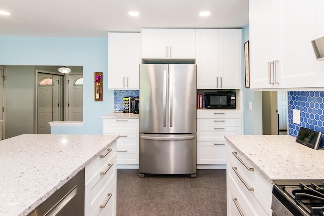 39079 Ross St, Livonia, MI 48154 - kitchen with freestanding refrigerator, black microwave, decorative backsplash, light stone counters, and recessed lighting
