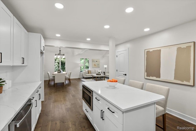 47043 Curtis Rd, Northville, MI 48168 - kitchen with appliances with stainless steel finishes, dark wood finished floors, white cabinetry, recessed lighting, and a kitchen breakfast bar