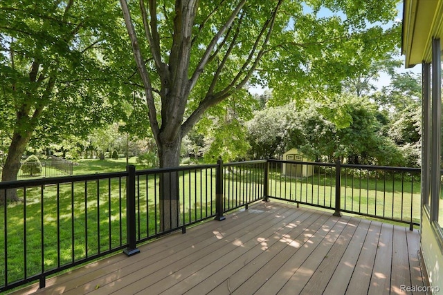 47043 Curtis Rd, Northville, MI 48168 - wooden deck with a shed, view of scattered trees, and a fenced backyard