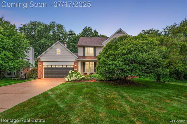 3066 Waldon Park Dr, Orion, MI 48359 - view of front of property featuring an attached garage, a front lawn, driveway, and brick siding