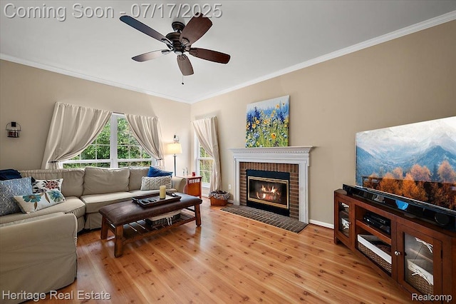 3066 Waldon Park Dr, Orion, MI 48359 - living room with crown molding, light wood-style flooring, a ceiling fan, and a fireplace