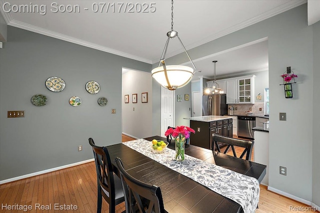3066 Waldon Park Dr, Orion, MI 48359 - dining room featuring light wood-style flooring and ornamental molding