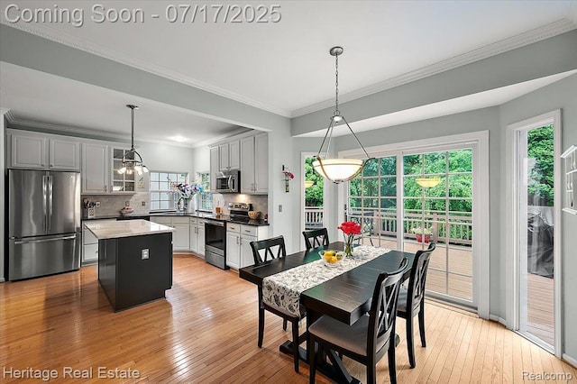 3066 Waldon Park Dr, Orion, MI 48359 - dining space featuring ornamental molding and light wood-style floors