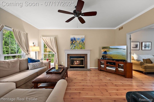 3066 Waldon Park Dr, Orion, MI 48359 - living area with wood finished floors, ceiling fan, ornamental molding, and a brick fireplace