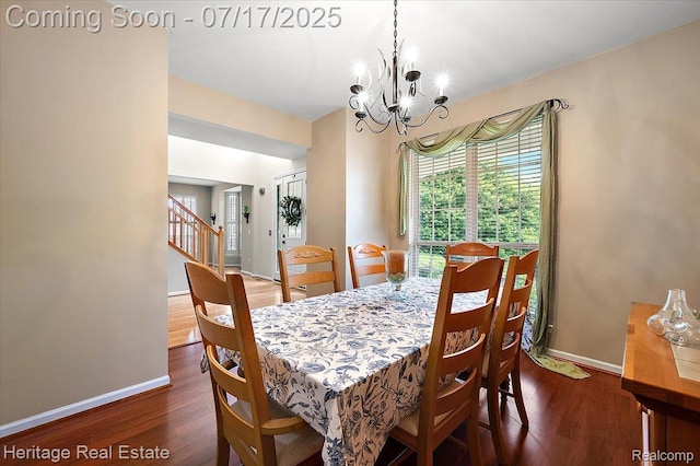 3066 Waldon Park Dr, Orion, MI 48359 - dining area with wood finished floors, a chandelier, and stairway