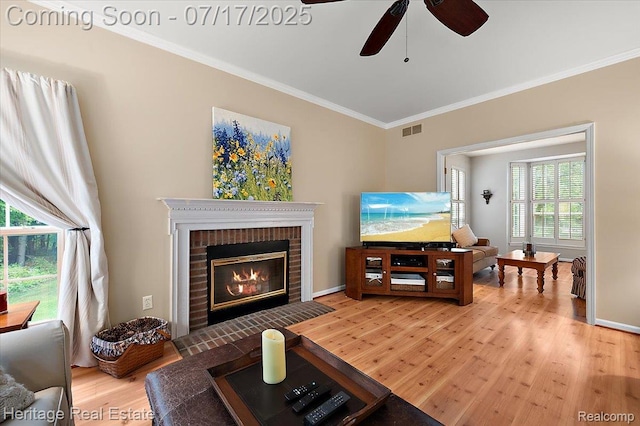 3066 Waldon Park Dr, Orion, MI 48359 - living room featuring light wood-type flooring, crown molding, a ceiling fan, and a fireplace
