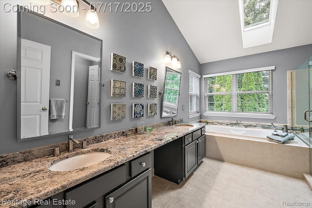 3066 Waldon Park Dr, Orion, MI 48359 - full bath with a bath, double vanity, vaulted ceiling, a skylight, and tile patterned flooring
