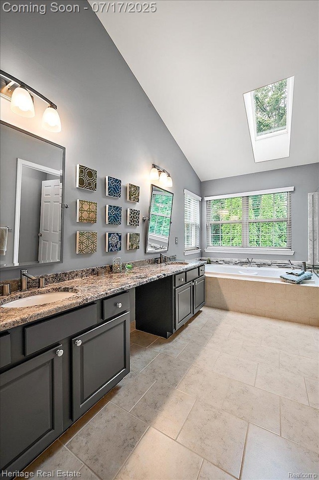 3066 Waldon Park Dr, Orion, MI 48359 - full bathroom with vanity, a garden tub, a skylight, and high vaulted ceiling