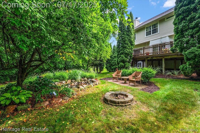 3066 Waldon Park Dr, Orion, MI 48359 - view of green lawn with a fire pit, a deck, and a patio