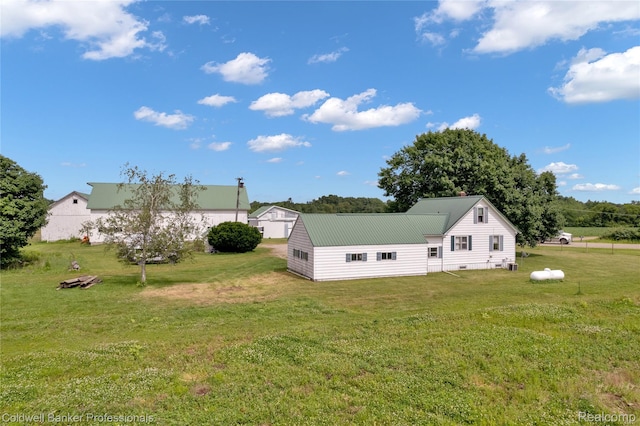4677 Imlay City Rd, Attica, MI 48412 - rear view of house with a lawn and a metal roof