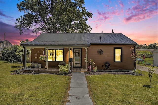 320 E Dr, Marshall, MI 49068 - bungalow-style house featuring a porch, a yard, and a metal roof