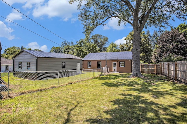 320 E Dr, Marshall, MI 49068 - rear view of property featuring a metal roof and a fenced backyard