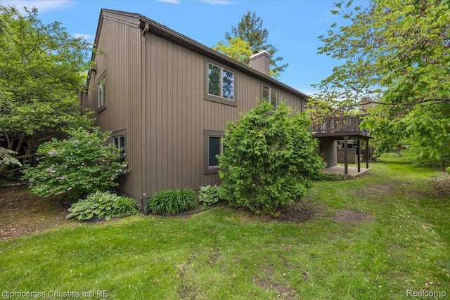 2 Eastbury Ct, Ann Arbor, MI 48105 - view of side of property with a yard, a chimney, and a deck