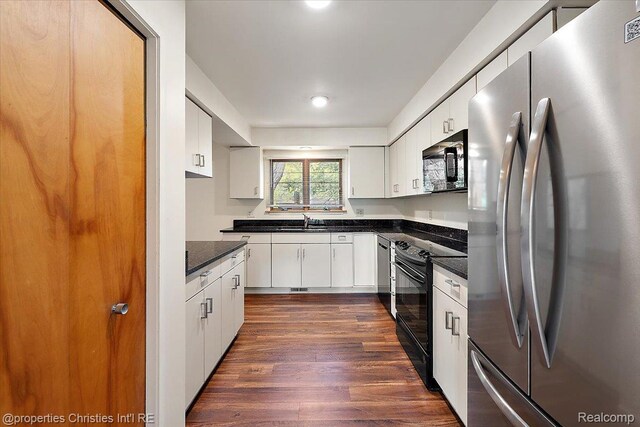 2 Eastbury Ct, Ann Arbor, MI 48105 - kitchen with black appliances, dark countertops, dark wood finished floors, and white cabinets
