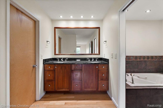 2 Eastbury Ct, Ann Arbor, MI 48105 - full bathroom featuring double vanity, wood finished floors, a bath, and recessed lighting