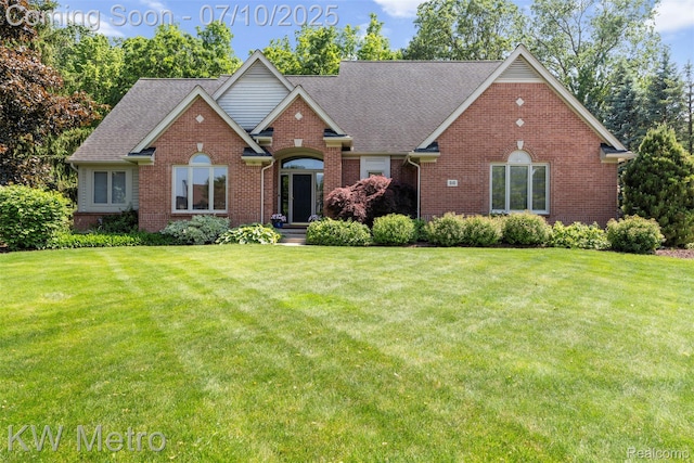 510 Roxbury Dr, Lake Orion, MI 48359 - traditional-style home with brick siding, a front yard, and a shingled roof