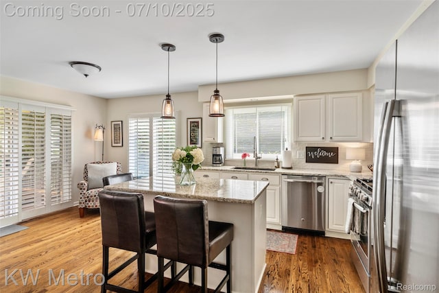 510 Roxbury Dr, Lake Orion, MI 48359 - kitchen with stainless steel appliances, tasteful backsplash, white cabinetry, and light stone countertops