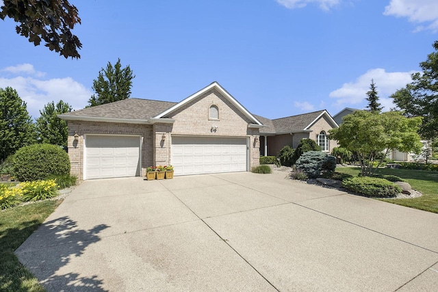 6177 Heathcross Dr, Hudsonville, MI 49426 - ranch-style home featuring a garage, brick siding, and concrete driveway
