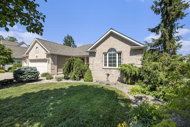 6177 Heathcross Dr, Hudsonville, MI 49426 - ranch-style house with brick siding, an attached garage, and a front yard