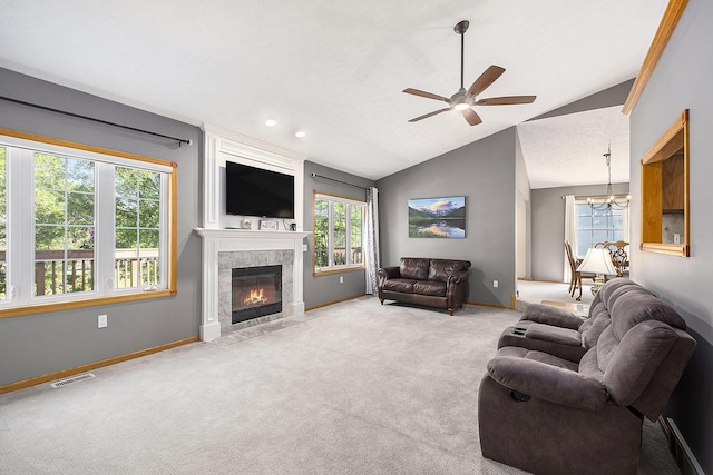 6177 Heathcross Dr, Hudsonville, MI 49426 - carpeted living area with ceiling fan, a tile fireplace, vaulted ceiling, and a chandelier