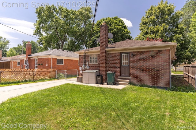 1432 N Custer Ave, Clawson, MI 48017 - rear view of house with entry steps, a chimney, and brick siding